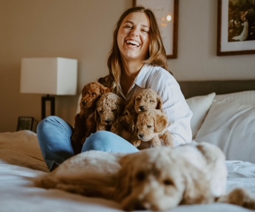 Woman with puppies and mom dog